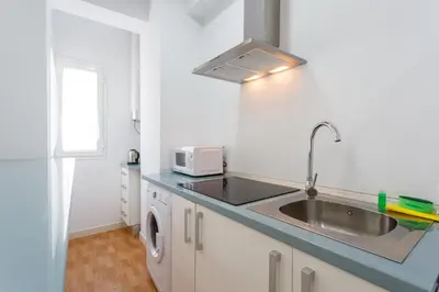 a kitchen with a sink and a microwave at Apartamentos El BALNEARIO by Cadiz4Rentals in Cádiz