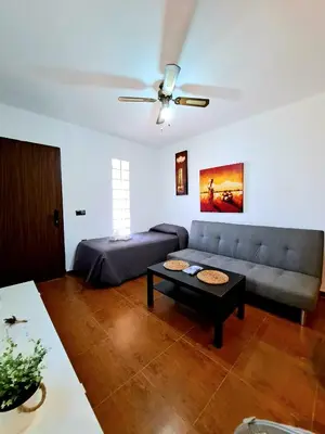 a living room with a couch and a table at Oasis de Cádiz in Conil de la Frontera