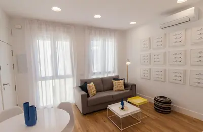 a living room with a couch and a table at Apartamento Barrocal in Cádiz