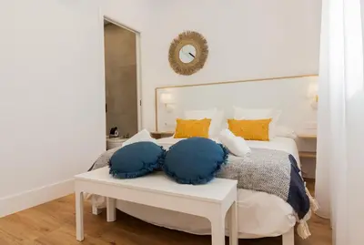 a bedroom with a bed with two pillows on a table at Apartamento Barrocal in Cádiz