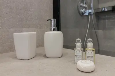 a bathroom counter with two bottles of soap and a bottle at Apartamento Barrocal in Cádiz