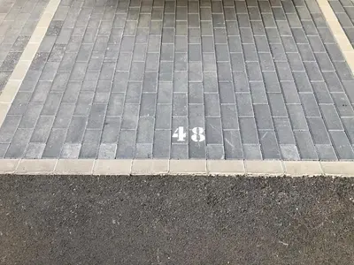 a parking lot with the number on the street at GATU PREMIUM Conil Sunset house con piscina, 3 dormit, 3 baños, jardín privado , wifi y parking, preferente mayores de 21 años y familias in Conil de la Frontera