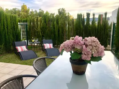 a vase of pink flowers sitting on a table at GATU PREMIUM Conil Sunset house con piscina, 3 dormit, 3 baños, jardín privado , wifi y parking, preferente mayores de 21 años y familias in Conil de la Frontera