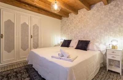 a bedroom with a bed with two towels on it at Los Corceles Casa Palacio in Jerez de la Frontera