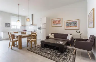 a living room with a table and a dining room at Los Corceles Casa Palacio in Jerez de la Frontera