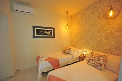 a small room with two beds and a couch at Los Corceles Casa Palacio in Jerez de la Frontera