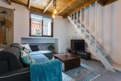 a living room with a couch and a tv at Los Corceles Casa Palacio in Jerez de la Frontera