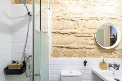 a bathroom with a sink and a mirror at Allo Apartments San Francisco Centro Loft in Jerez de la Frontera