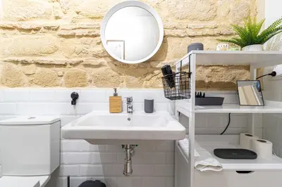 a bathroom with a sink and a mirror at Allo Apartments San Francisco Centro Loft in Jerez de la Frontera