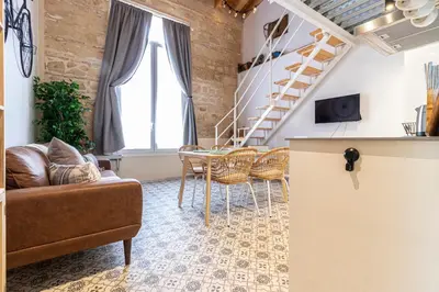 a living room with a couch and a table at Allo Apartments San Francisco Centro Loft in Jerez de la Frontera