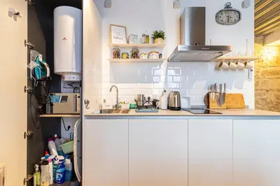 a kitchen with white cabinets and a sink at Allo Apartments San Francisco Centro Loft in Jerez de la Frontera