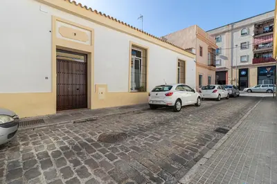 a group of parked cars parked on a street at Allo Apartments San Francisco Centro Loft in Jerez de la Frontera