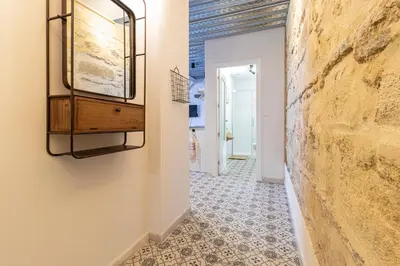 a hallway with a mirror and a tile floor at Allo Apartments San Francisco Centro Loft in Jerez de la Frontera
