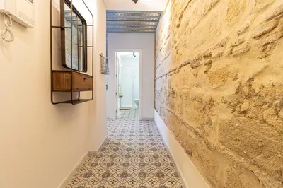 a hallway with a stone wall and a tile floor at Allo Apartments San Francisco Centro Loft in Jerez de la Frontera