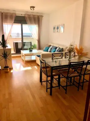 a living room with a table and a couch at GATU PREMIUM Ático Parra, parking, piscina común, terraza, wifi , 