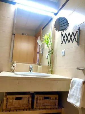 a bathroom with a sink and a mirror at GATU PREMIUM Ático Parra, parking, piscina común, terraza, wifi , 
