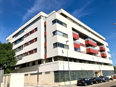 a large white building with cars parked in front of it at GATU PREMIUM Ático Parra, parking, piscina común, terraza, wifi , 
