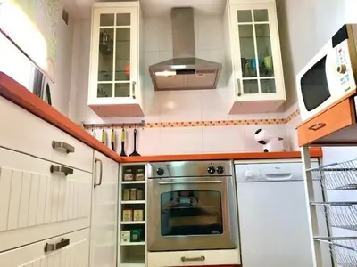 a small kitchen with a stove and a oven at GATU PREMIUM Ático Parra, parking, piscina común, terraza, wifi , 