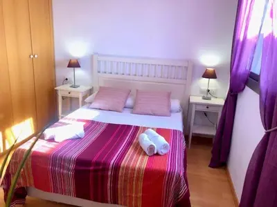 a bedroom with a large bed with two night stands at GATU PREMIUM Ático Parra, parking, piscina común, terraza, wifi , 