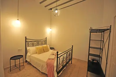 a bedroom with a bed and a ladder and lights at Apartamentos Casa Rosaleda in Jerez de la Frontera