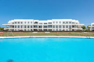 a large building with a large pool in front of it at Costa Ballena Terrace Beach House in Costa Ballena