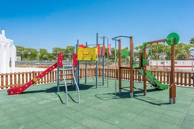 a row of playground equipment in a park at Costa Ballena Terrace Beach House in Costa Ballena