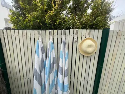 a hat and two towels on a fence at Costa Ballena Terrace Beach House in Costa Ballena