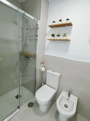 a bathroom with a toilet and a glass shower at Costa Ballena Terrace Beach House in Costa Ballena