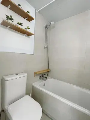 a bathroom with a white toilet and a bath tub at Costa Ballena Terrace Beach House in Costa Ballena
