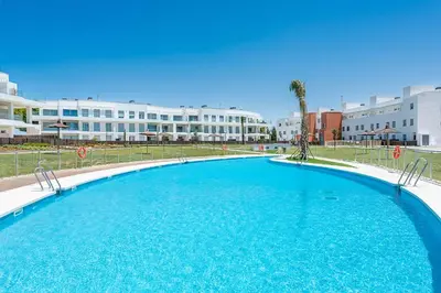 a large swimming pool in front of a building at Costa Ballena Terrace Beach House in Costa Ballena