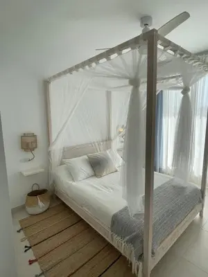 a white bed with a canopy in a room at Costa Ballena Terrace Beach House in Costa Ballena