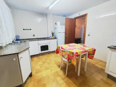 a kitchen with a table and a kitchen with a refrigerator at Beach Apartment La Costilla - Free Parking in Rota