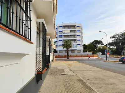 a city street with a building and a sidewalk at Beach Apartment La Costilla - Free Parking in Rota