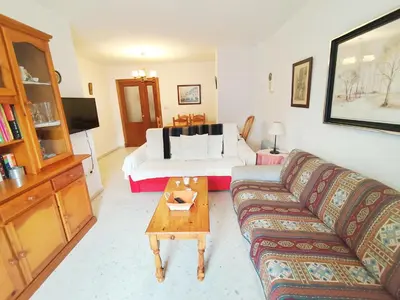 a living room with a couch and a bed at Beach Apartment La Costilla - Free Parking in Rota