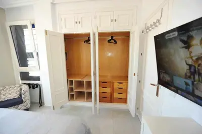 a bedroom with a bed and a tv in a room at Preciado apartamento con vistas frontales al mar in Cádiz