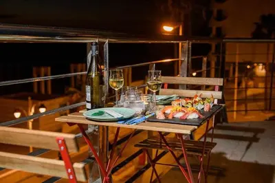 a table with a plate of food and glasses of wine at Preciado apartamento con vistas frontales al mar in Cádiz