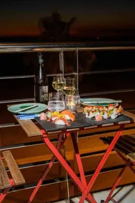 a table with two plates and glasses of wine at Preciado apartamento con vistas frontales al mar in Cádiz