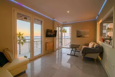 a living room with a view of the ocean at Preciado apartamento con vistas frontales al mar in Cádiz