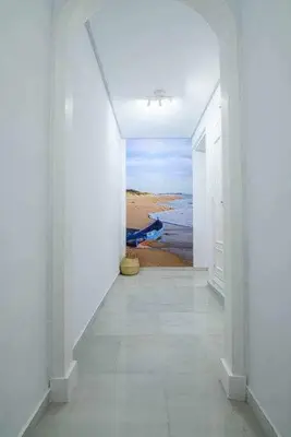 an empty hallway with a painting of the ocean at Preciado apartamento con vistas frontales al mar in Cádiz