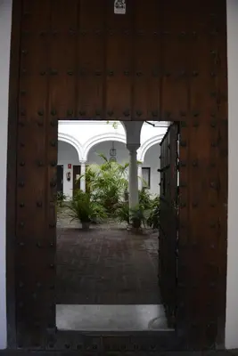 an open door to a building with a courtyard at CASA PALACIO LAS PALOMAS in Sanlúcar de Barrameda