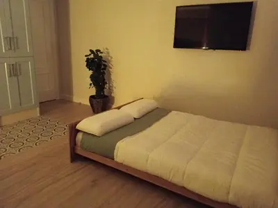 a bedroom with a bed with a tv on the wall at Estudio jacuzzi Luz de Jerez in Jerez de la Frontera