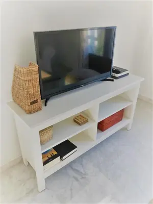 a tv sitting on a white entertainment center at El Envero Apartamento in Jerez de la Frontera