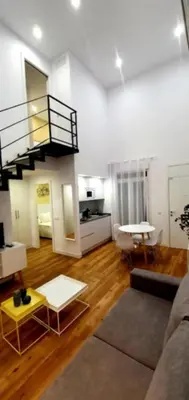 a living room with a couch and a staircase at Guesting Barrocal in Cádiz