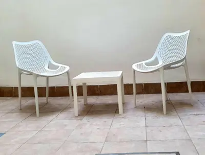 two white chairs and a table in a room at Guesting Barrocal in Cádiz