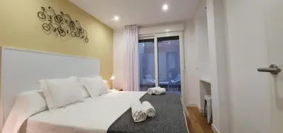 a bedroom with a white bed with shoes on it at Guesting Barrocal in Cádiz
