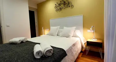 a bedroom with a large bed with towels on it at Guesting Barrocal in Cádiz