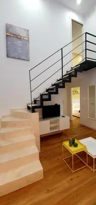 a living room with a staircase and a tv at Guesting Barrocal in Cádiz