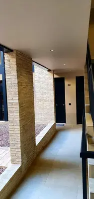 a hallway with black doors in a building at Guesting Barrocal in Cádiz