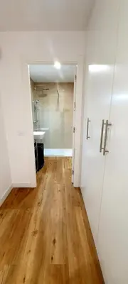 an empty room with a bathroom and a hallway with wooden floors at Guesting Barrocal in Cádiz