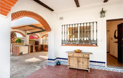 a kitchen with an archway and a table in a house at Lovely Home In Chiclana De La Fronter in Novo Sancti Petri